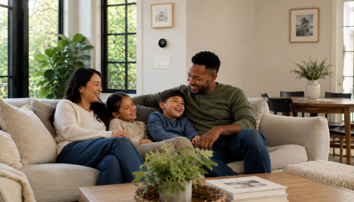 Family relaxing together in a bright modern Charlottesville, Virginia living room after a new heat pump installation.