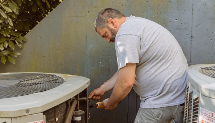 An expert heating and air technician repairs an HVAC system in Charlottesville, VA.
